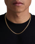 Model wearing 5mm 18k gold plain cuban necklace by Iceman Society
